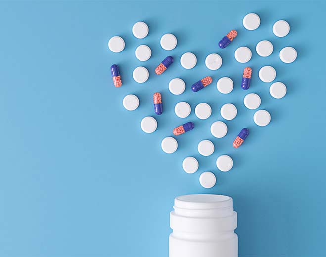 Heart-shaped arrangement of pills and capsules