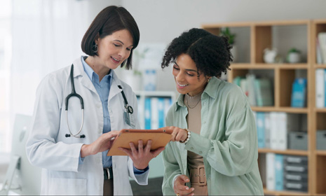 Doctor reviewing chart with patient in clinic
