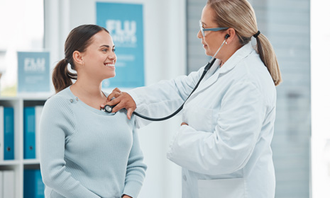 Clinician performing chest exam with stethoscope