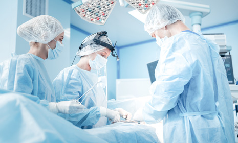 Surgical team performing procedure in operating room