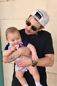 Rey Padilla being held by father