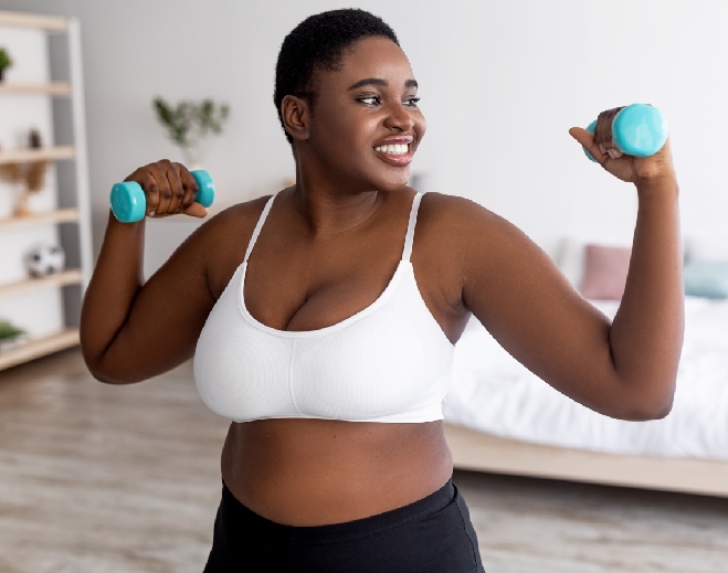 Woman lifting light blue dumbbells